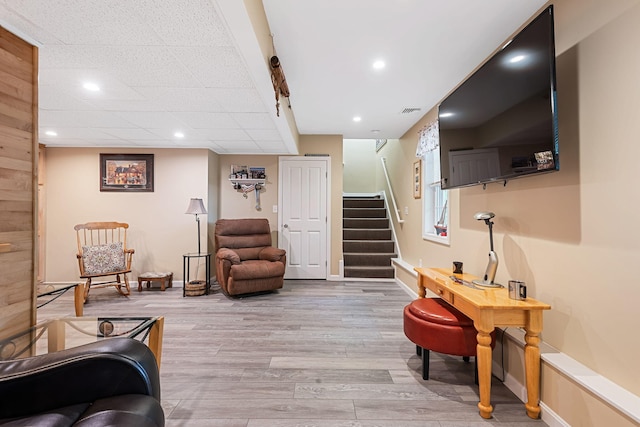 living area featuring recessed lighting, visible vents, baseboards, light wood-style flooring, and stairs