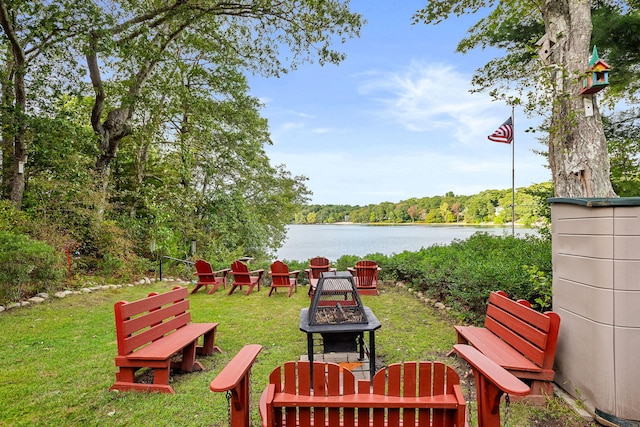 view of yard featuring a fire pit and a water view