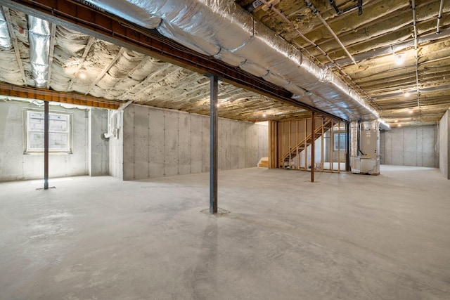 below grade area featuring heating unit and stairway