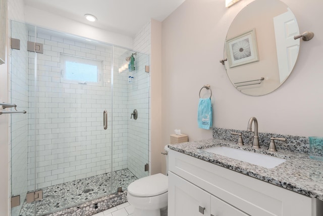 full bathroom with toilet, vanity, and a stall shower