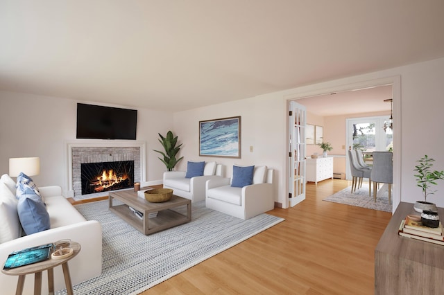 72 Lookout Rd, Yarmouth Port, MA 02675 - living area with a brick fireplace, light wood-type flooring, and french doors