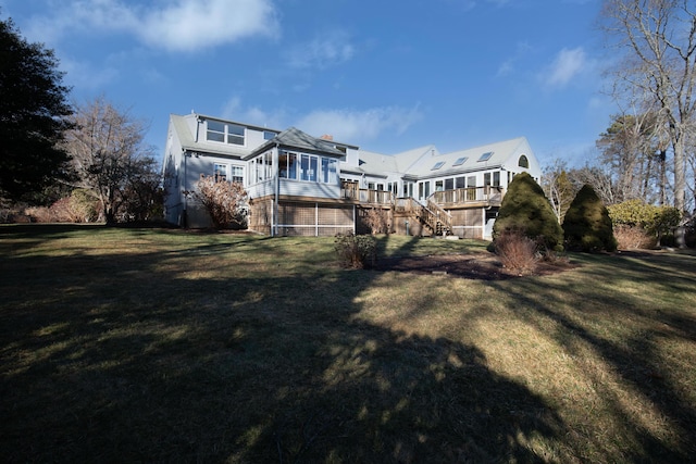 72 Lookout Rd, Yarmouth Port, MA 02675 - rear view of house featuring stairway, a sunroom, a lawn, and a deck