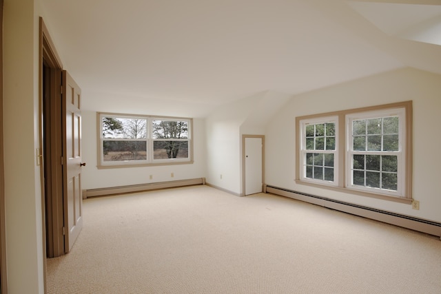 bonus room with vaulted ceiling, light carpet, and a baseboard heating unit