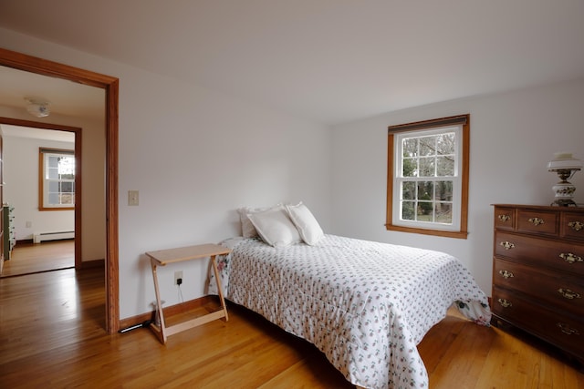 72 Lookout Rd, Yarmouth Port, MA 02675 - bedroom featuring light wood finished floors, multiple windows, and baseboard heating