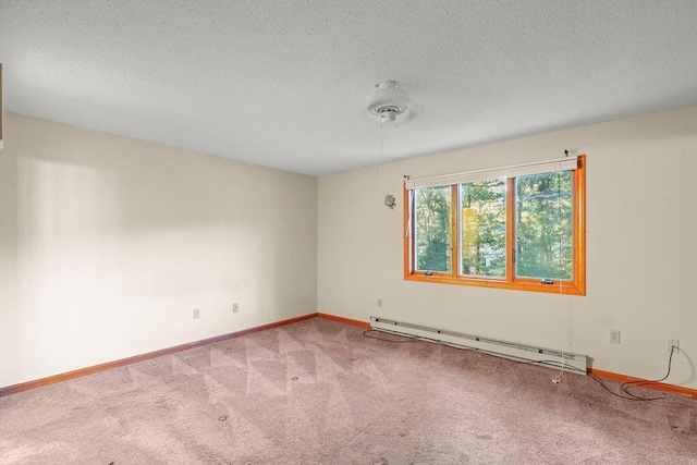 empty room with a textured ceiling, baseboard heating, and carpet floors