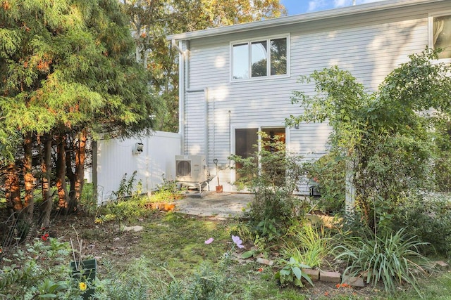 view of side of home with ac unit and a patio