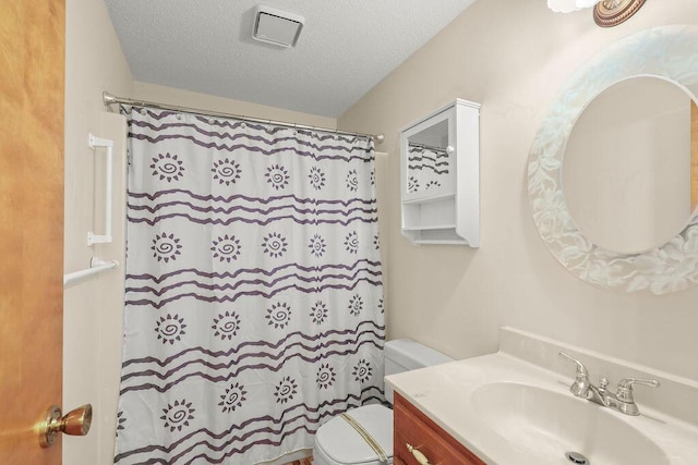 bathroom with vanity, toilet, a textured ceiling, and a shower with shower curtain