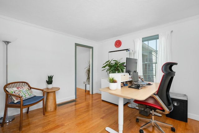 office featuring ornamental molding, light wood finished floors, and baseboards