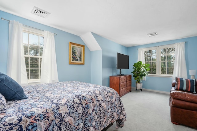 carpeted bedroom with visible vents, baseboards, and multiple windows