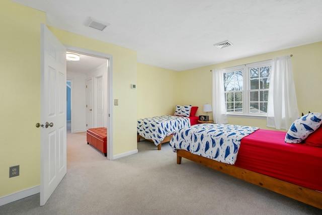 bedroom with baseboards, visible vents, and carpet flooring