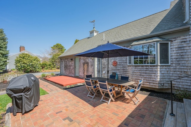 view of patio / terrace featuring outdoor dining space and a grill
