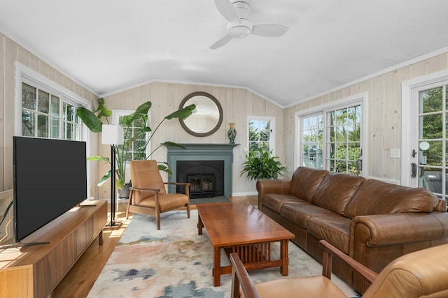 living room with ornamental molding, ceiling fan, wood finished floors, and lofted ceiling