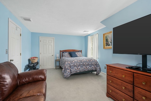 bedroom featuring visible vents, light colored carpet, and baseboards