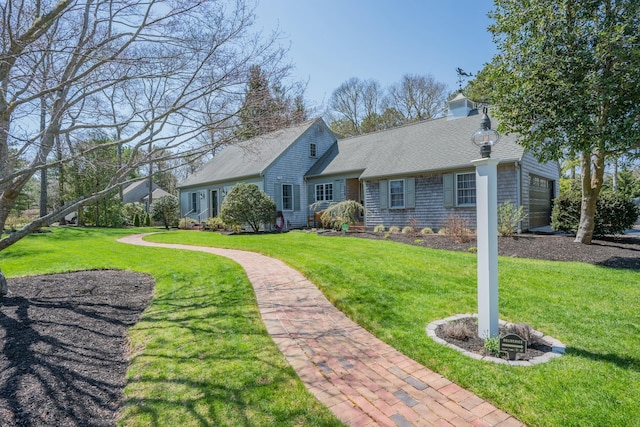 single story home with a garage, a front lawn, and roof with shingles