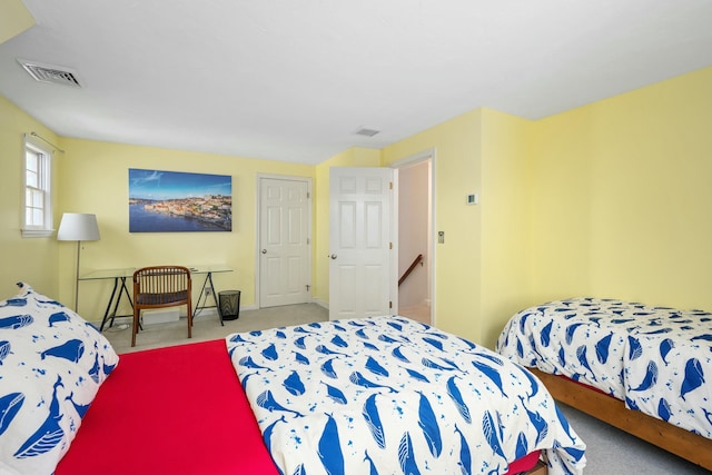 bedroom with carpet flooring, visible vents, and baseboards