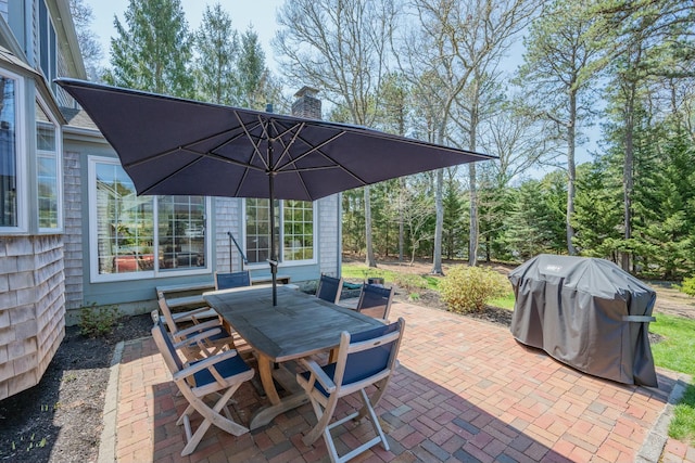 view of patio / terrace featuring outdoor dining area and a grill