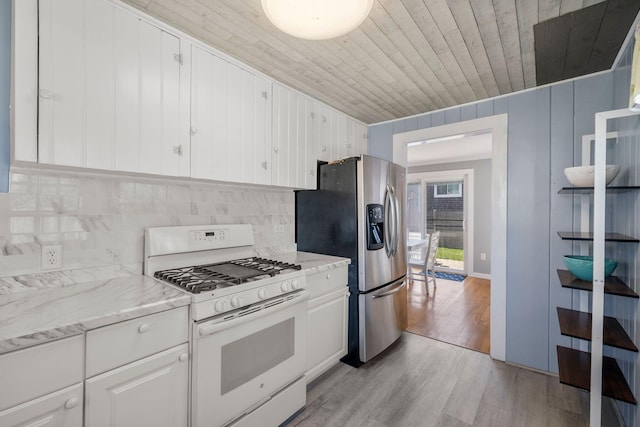 kitchen featuring white gas range oven, stainless steel fridge with ice dispenser, wood ceiling, light wood-style flooring, and white cabinets