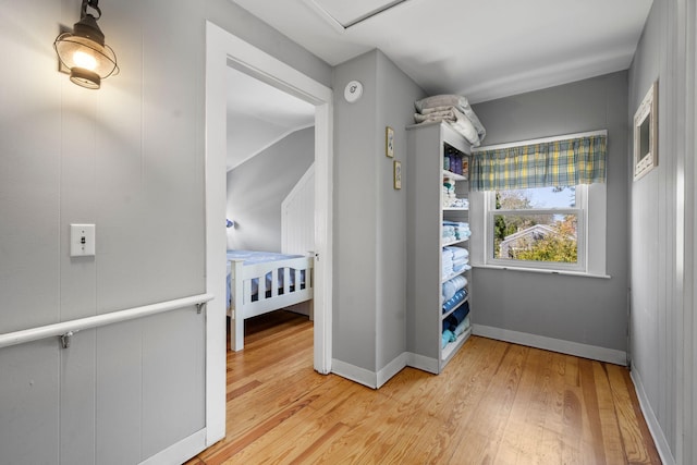 bedroom with light wood-style flooring and baseboards