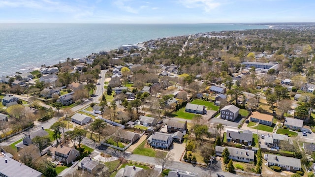aerial view of property and surrounding area with a nearby body of water and nearby suburban area