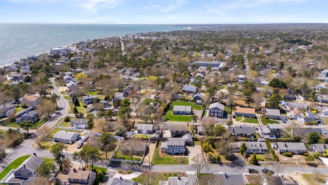 aerial view of property and surrounding area with nearby suburban area and a large body of water