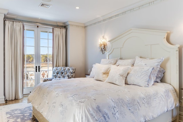 bedroom featuring access to outside, ornamental molding, light hardwood / wood-style floors, and french doors