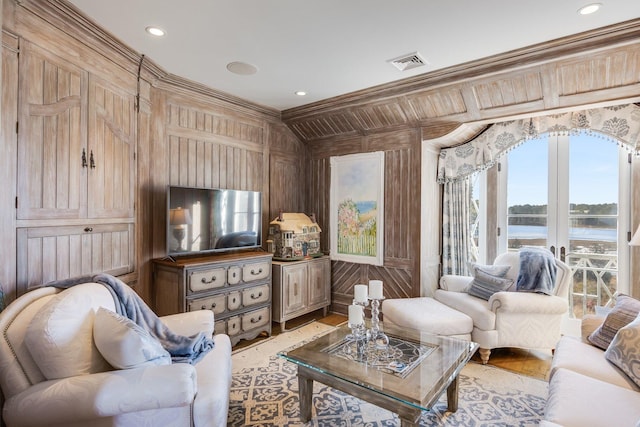 living room featuring ornamental molding and wood walls