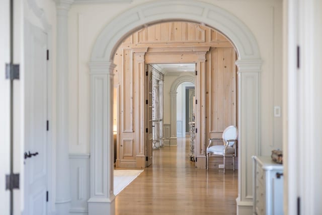 corridor with crown molding and light hardwood / wood-style flooring