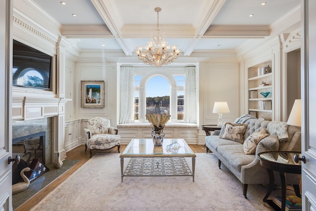 living room with coffered ceiling, beamed ceiling, built in features, hardwood / wood-style flooring, and a premium fireplace