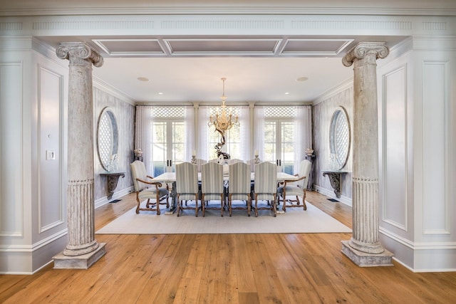 dining room with ornamental molding, light hardwood / wood-style flooring, and ornate columns