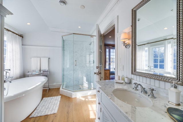 bathroom with vanity, hardwood / wood-style floors, crown molding, and independent shower and bath