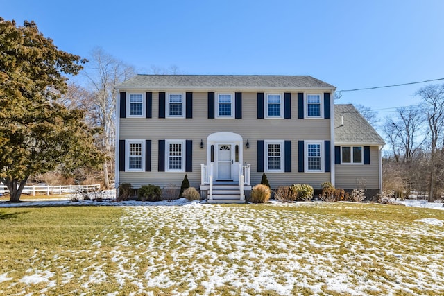 colonial home featuring a lawn