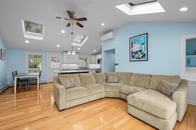 359 Lake Elizabeth Dr, Centerville, MA 02632 - living area featuring a skylight, lofted ceiling, a wall mounted air conditioner, ceiling fan, and light wood-style floors
