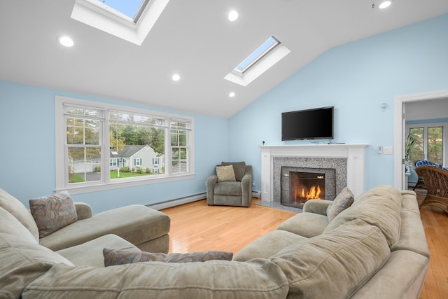 359 Lake Elizabeth Dr, Centerville, MA 02632 - living room with a skylight, a baseboard radiator, vaulted ceiling, wood finished floors, and a premium fireplace