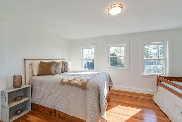 bedroom featuring wood finished floors and baseboards