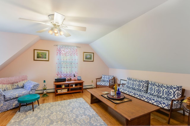 living room with a baseboard radiator, lofted ceiling, wood finished floors, and a ceiling fan