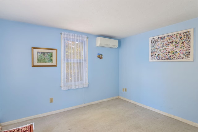 spare room featuring baseboards, carpet, and a wall unit AC