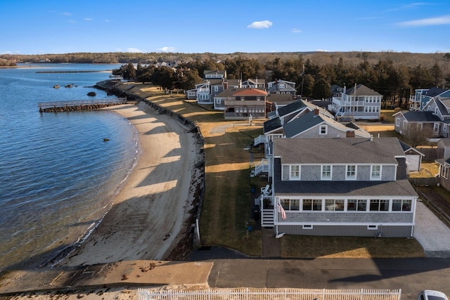 birds eye view of property with a water view and a view of the beach