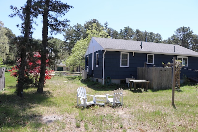 25 Day Rd, Wellfleet, MA 02667 - back of property featuring fence, central air condition unit, and roof with shingles
