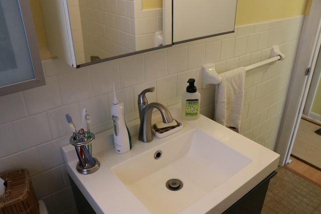 bathroom featuring vanity and tile walls