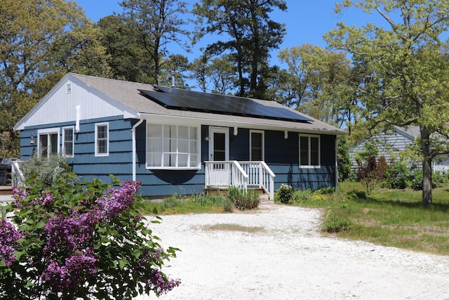 25 Day Rd, Wellfleet, MA 02667 - view of front of house with roof mounted solar panels and roof with shingles