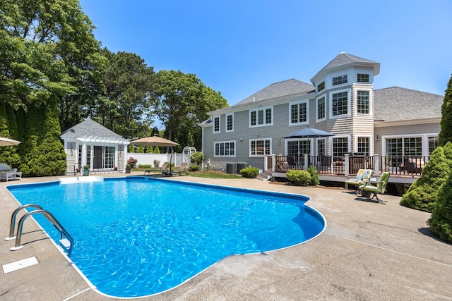 335 Falmouth Woods Rd, East Falmouth, MA 02536 - view of swimming pool featuring a wooden deck, an outdoor structure, a storage structure, and a patio