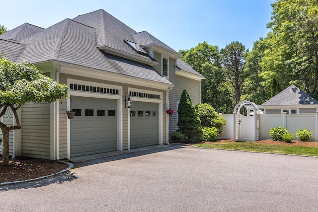 335 Falmouth Woods Rd, East Falmouth, MA 02536 - view of side of home featuring driveway and roof with shingles