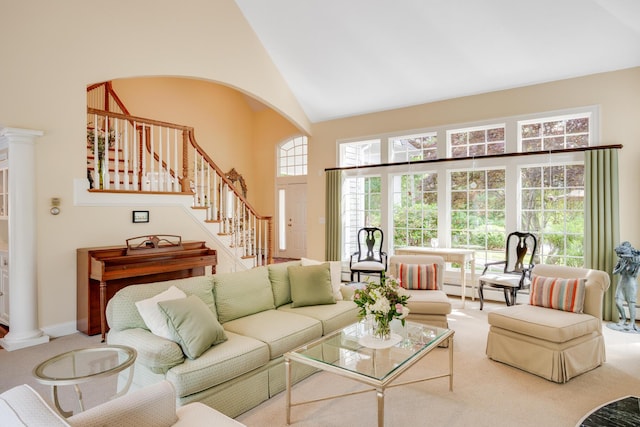 335 Falmouth Woods Rd, East Falmouth, MA 02536 - living area featuring stairway, high vaulted ceiling, carpet floors, a baseboard radiator, and ornate columns