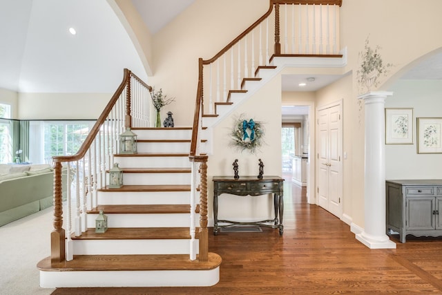 335 Falmouth Woods Rd, East Falmouth, MA 02536 - staircase featuring arched walkways, healthy amount of natural light, a high ceiling, wood finished floors, and recessed lighting