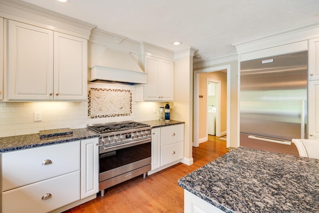 335 Falmouth Woods Rd, East Falmouth, MA 02536 - kitchen featuring high end appliances, premium range hood, light wood-type flooring, white cabinetry, and recessed lighting