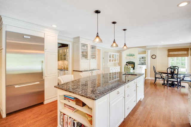 335 Falmouth Woods Rd, East Falmouth, MA 02536 - kitchen with built in refrigerator, decorative columns, open shelves, white cabinetry, and recessed lighting