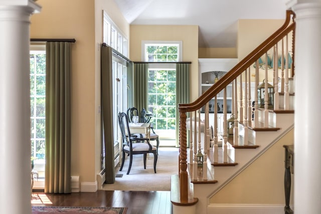 335 Falmouth Woods Rd, East Falmouth, MA 02536 - entryway with dark wood-style floors, stairway, and decorative columns
