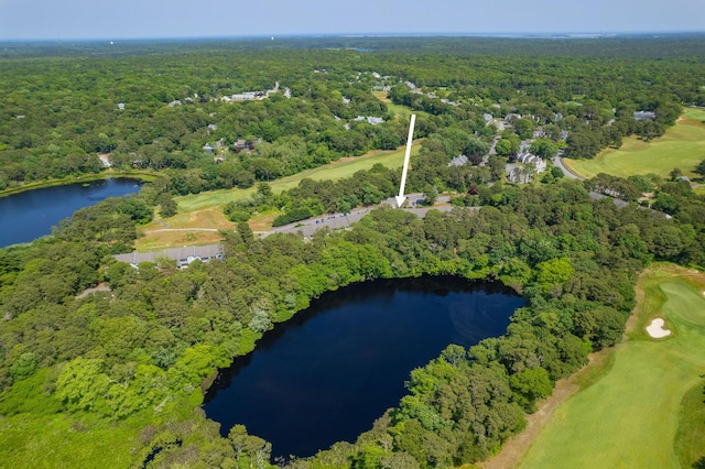 birds eye view of property with a forest view, view of golf course, and a water view