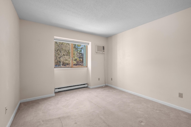spare room featuring baseboard heating, a textured ceiling, baseboards, and carpet floors