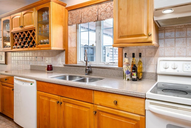 30 Monomessat Way, Chatham, MA 02633 - kitchen with white appliances, under cabinet range hood, a sink, light countertops, and glass insert cabinets